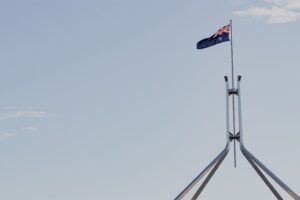 Australian flag flying above Parliament House